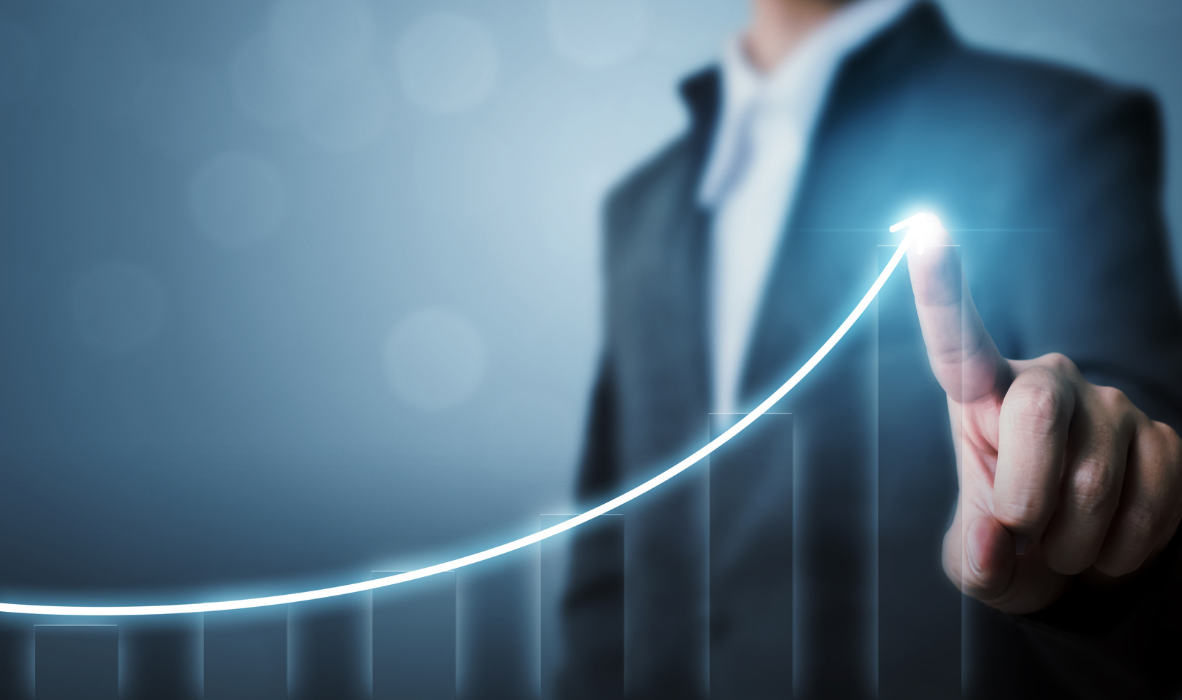 Man highlighting graph of upward growth after moving telco billing to Active Billing